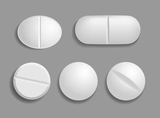 Set of medical white tablets. Flat and convex pills in 3D style with shadow are isolated on gray background. Top view. Realistic vector illustration