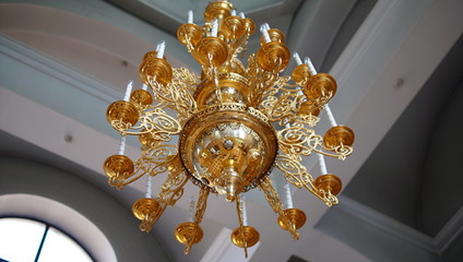 Chandelier in the Church. Candles Are Lit on the Chandelier in Orthodox Church.