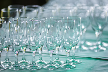 lot of empty glasses on the reception party table. Close up at row of glasses prepare to service for dinner party