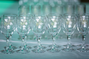 lot of empty glasses on the reception party table. Close up at row of glasses prepare to service for dinner party