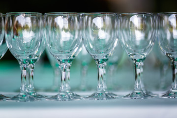 lot of empty glasses on the reception party table. Close up at row of glasses prepare to service for dinner party