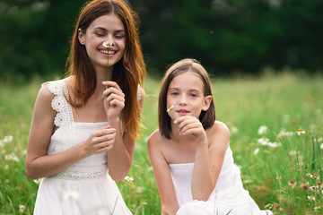 Fototapeta premium two girls talking on cell phone in the park