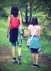 Mother and daughter walks in the path with old toned effect