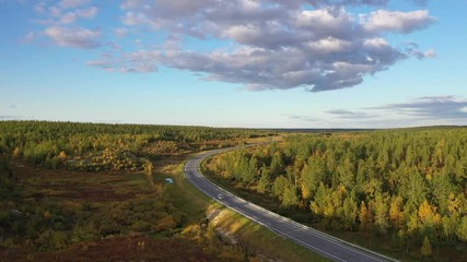 Autumn top view of the road and the car in the North of Western Siberia
