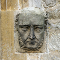 Grotesque stone face on an ancient church, Aysgarth, North Yorkshire