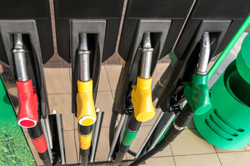 Gas and petrol station. Guns for refueling at a gas station. Detail of a petrol pump different colors in gas station. Close up on fuel nozzle in oil dispenser with gasoline and diesel