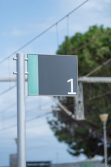 Metal plate with number one framed in wire.