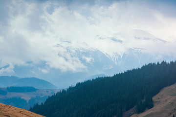 Naklejka premium Foggy hills and gloomy mood of the scene of the alpine valley.