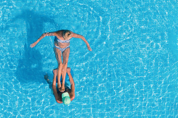 Man and woman in hotel swimming pool.