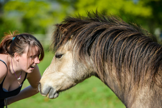 young girl with a horse, smiling and laughing. 