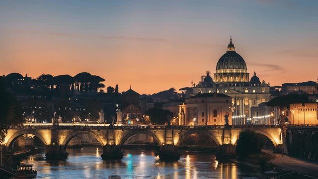 Rome, Italy. Papal Basilica Of St. Peter In The Vatican And Aelian Bridge In Evening Night Illuminations. Day To NIght Time Lapse. Sunset Time.