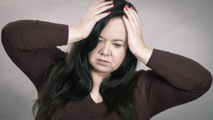 Worried woman having painfull headache