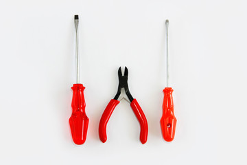 old rusty metal screwdrivers and pliers nippers with red plastic handles