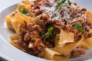 Italian ragu bolognese with flat fettuccine pasta
