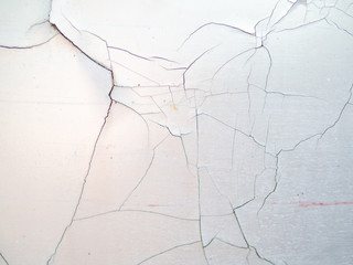 Texture of a white cracked plaster wall