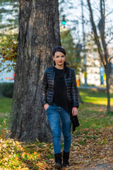 Young Woman Walking in a Park in Autumn