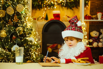 Fototapeta na wymiar Santa Claus writes the letter to children. Santa Claus enjoys cookies and milk left out for him on Christmas eve.