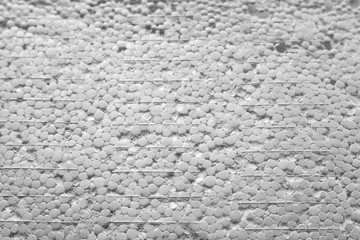 The texture of expanded polystyrene closeup. Sound and thermal insulation for construction, production of containers and lodges.