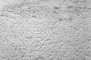 The texture of expanded polystyrene closeup. Sound and thermal insulation for construction, production of containers and lodges.