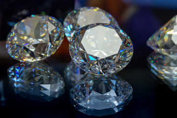 faceted gemstones. diamonds on a dark background