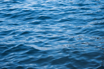 Naklejka premium Blue sea wave ripple curl water surface texture. Summer holiday relax background with copy space.