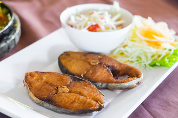 Fried king mackerel fish served with sweet and sour spicy sauce.