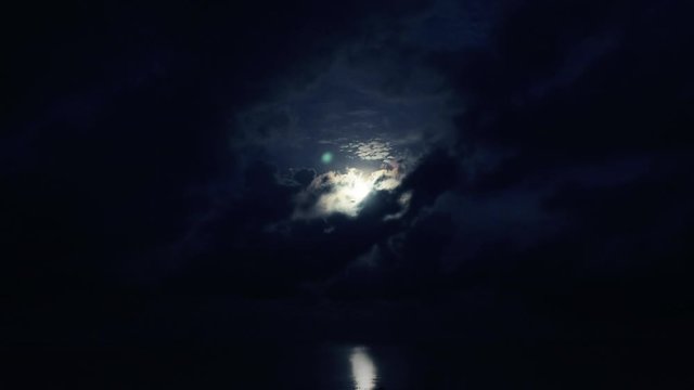 Time Lapse of a Moonset in the Middle of the Ocean During The End of the Night until Early Morning Sunlight with Slight Lunar Reflection on the Ocean Surface