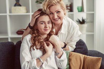 Mother embracing daughter at home