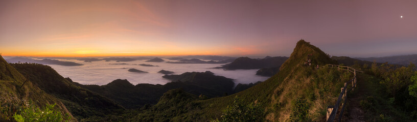Naklejka na ściany i meble Panoramic view morning sunrise at Phu Chi Dao, the unseen spot of sea fog on mountain peak in Chiang Rai, Thailand. Panorama nature landscape
