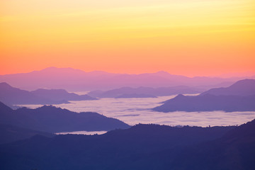 Fototapeta na wymiar Dramatic sunset and sunrise over mountain sea of fog morning twilight evening sky.