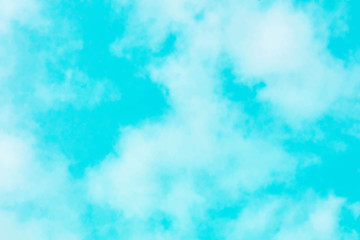 Fototapeta na wymiar Abstract vector background texture of a vibrant teal blue sky with soft white clouds