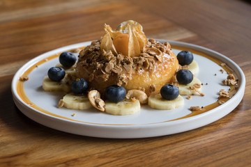 Peanut Butter Cake with Granola Close up on Wooden Table