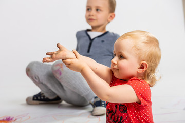 Sister and brother, children playing. Dirty hands