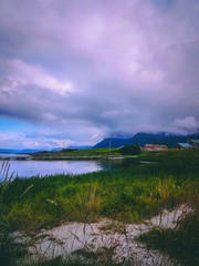 Photo of norway with sea, cloudy sky on summer evening .