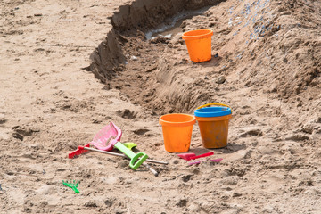 Shovel next to a sand castle on a beach in Brittany