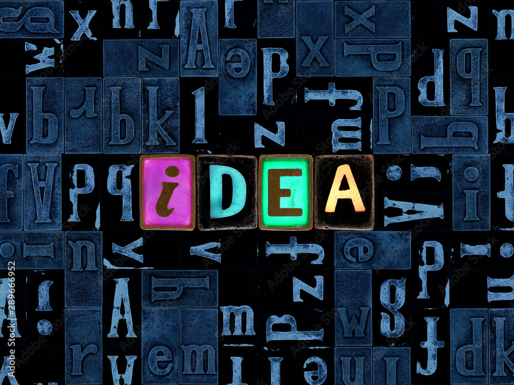 Fototapete the word idea as letters, unique typeset symbols over abstract mosaic pattern background