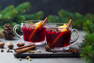 Mulled red wine with spices. Christmas decoration. Grey stone background. Copy space.