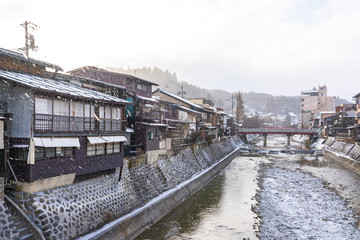 Fototapeta na wymiar Takayama old town with snow falling in Gifu, Japan