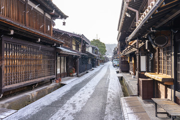 Takayama old town with snow falling in Gifu, Japan