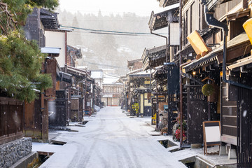 Takayama old town with snow falling in Gifu, Japan