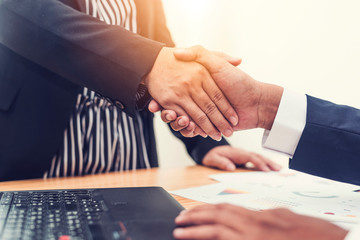 Asian businessman and businesswomen Handshaking.Successful businessmen handshaking after good deal.Handshake Gesturing People Connection Deal Concept.vintage color tone.