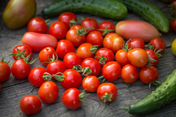  Cherry tomatoes and cucumbers on a wooden table