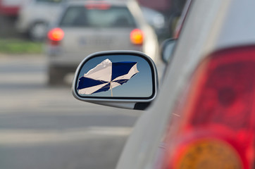 Looking in the side rear-view mirror during the traffic jam