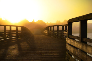 footbridge in the mist at early morning sunrise
