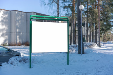 empty blank poster display on snowy winter park, building background, mock-up