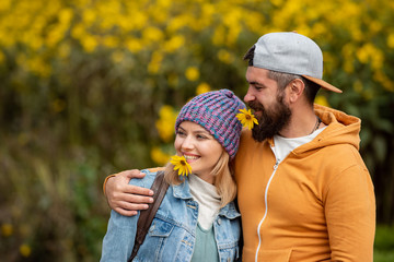 Fototapeta premium Young couple with autumnal mood. Fall concept. Outdoor autumn portrait Gorgeous models with sunny day light. Romantic portrait of a sensual couple in love. Intimate moments for happy lovers.