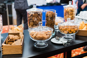 Shortbread cookies in glassware and other sweets on the buffet table during the coffee break