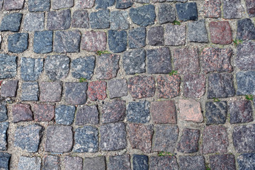 Old paving cobblestone outdoors as background top view close up