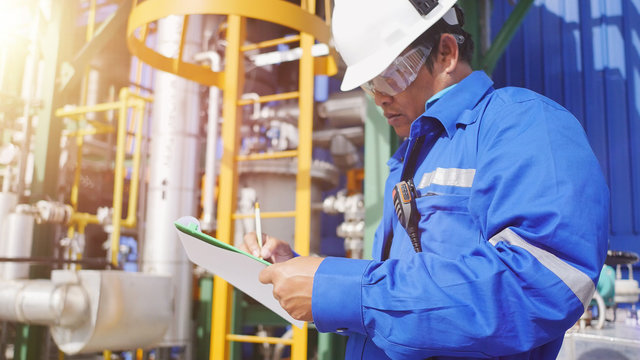Production engineer to working in petroleum refinery plant to check equipment in factory and record to check sheet