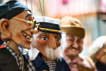 Selective focus of old sailor Puppets hanging at the souvenir store.